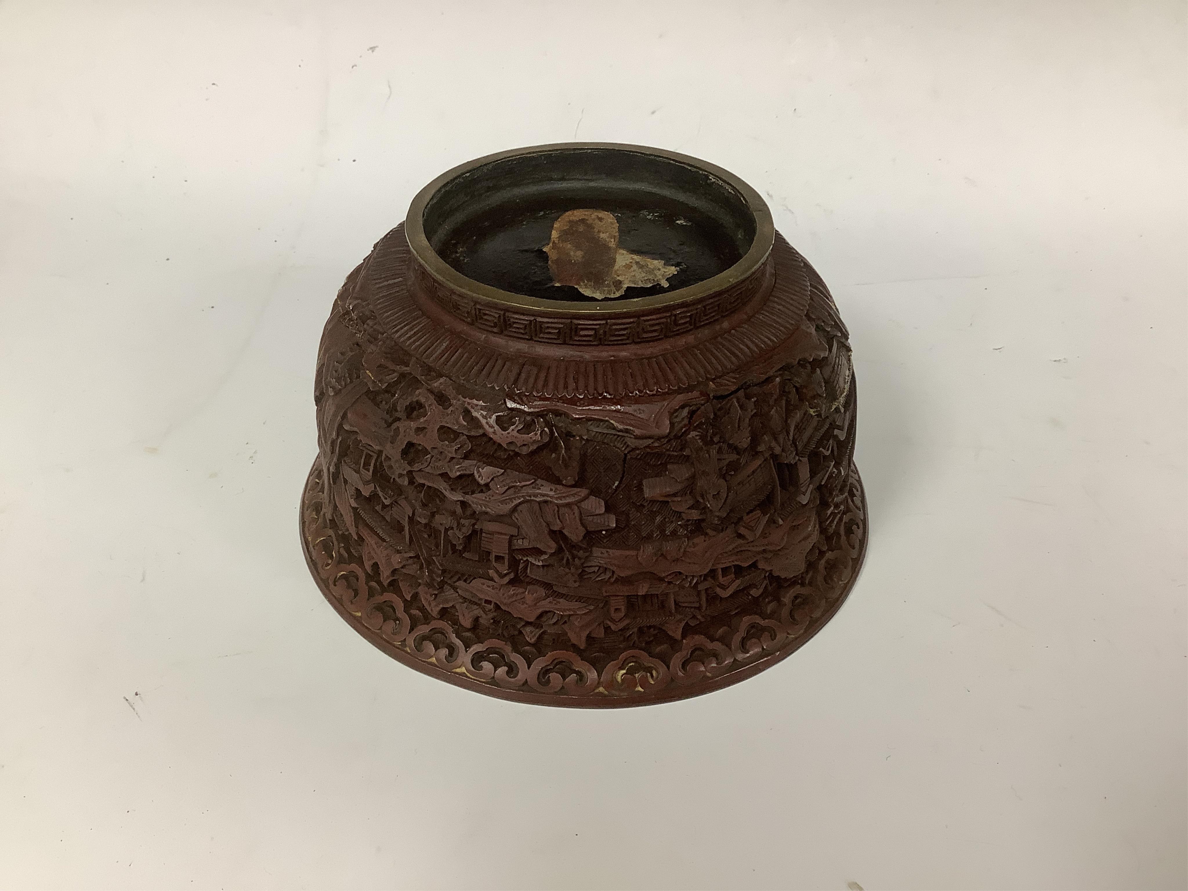 An 18th/19th century Chinese cinnabar lacquer bowl, on carved hongmu stand and a Chinese pierced brass disc. Condition - poor